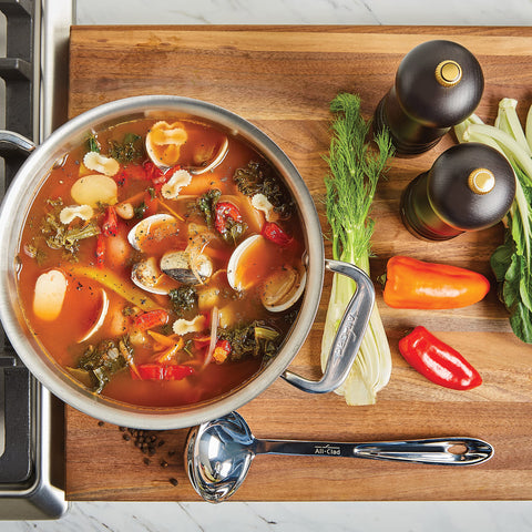 All-Clad turner and tongs flipping food showing secure control benefit