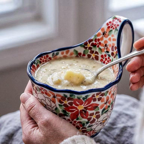 ALMA bowl next to spoon and cup showing scale and serving versatility