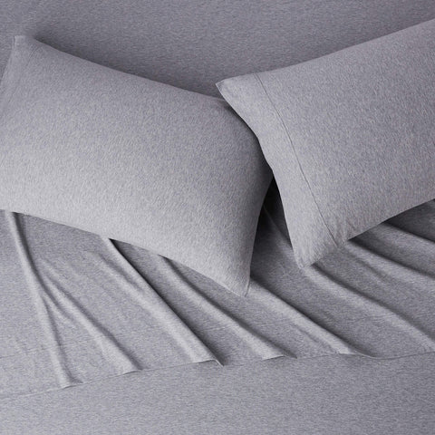 Amazon Basics light gray sheets on made bed illustrating neutral style and comfort