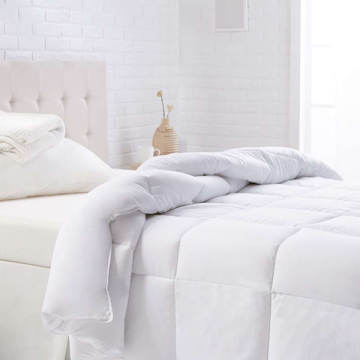 Amazon Basics front packaging of twin comforter shows neat fold and benefit of easy storage