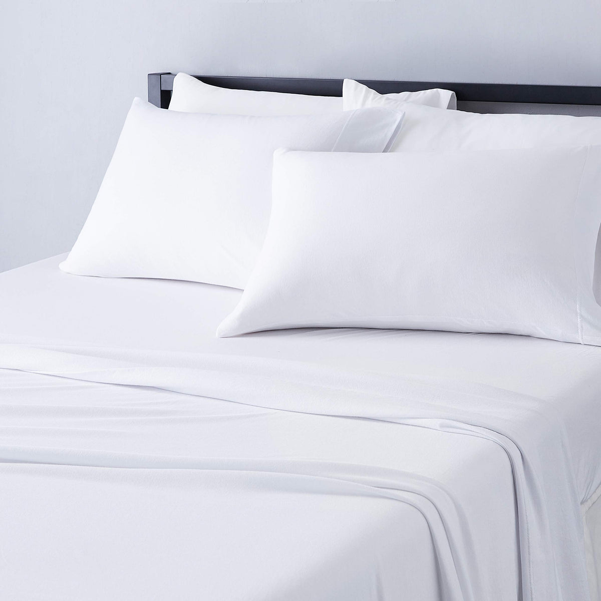 Amazon Basics front view of full sheet set showing clean white bedding and inclusive pieces