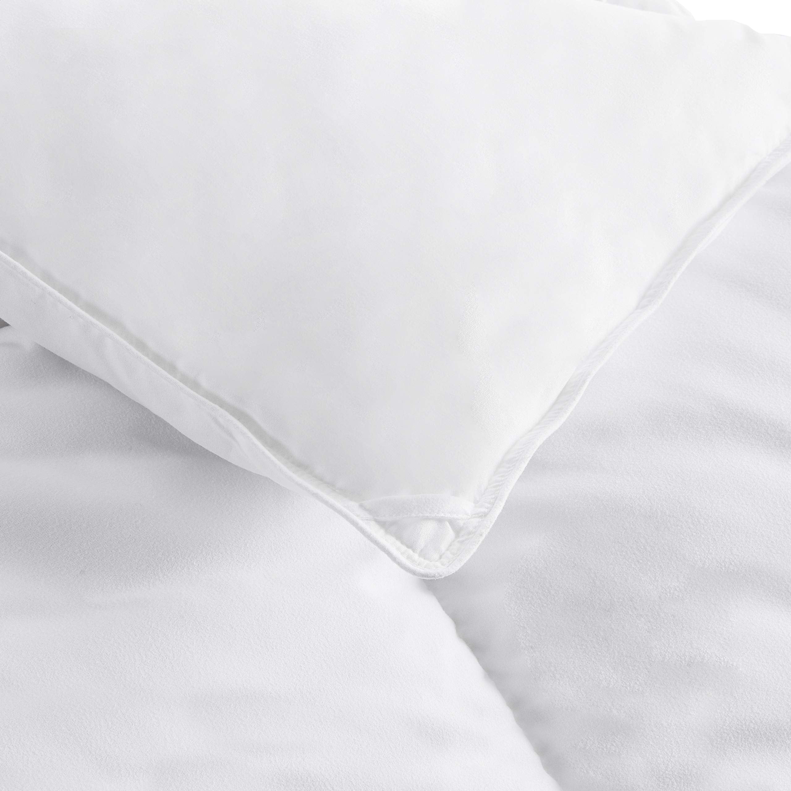 Amazon Basics comforter on bed in bedroom scene illustrating lightweight comfort