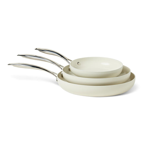 Amazon Basics ivory 3-piece set front view showing pans and ergonomic handles for easy handling