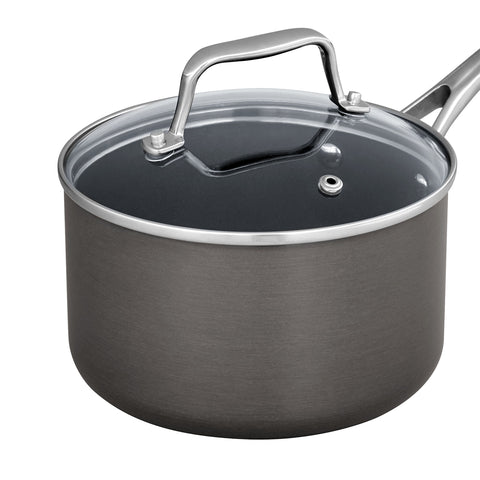 Amazon Basics saucepan beside measuring cup showing scale and compact storage benefit