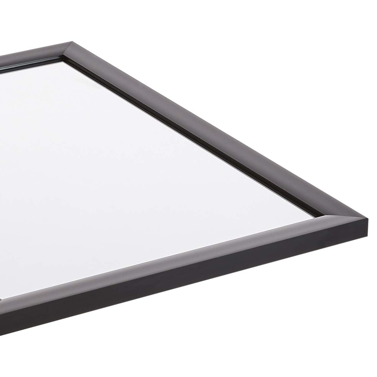 Amazon Basics mirror mounted vertically in bedroom creating taller visual space