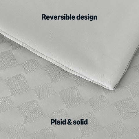Amazon Basics comforter on a made queen bed illustrating cool, layered styling