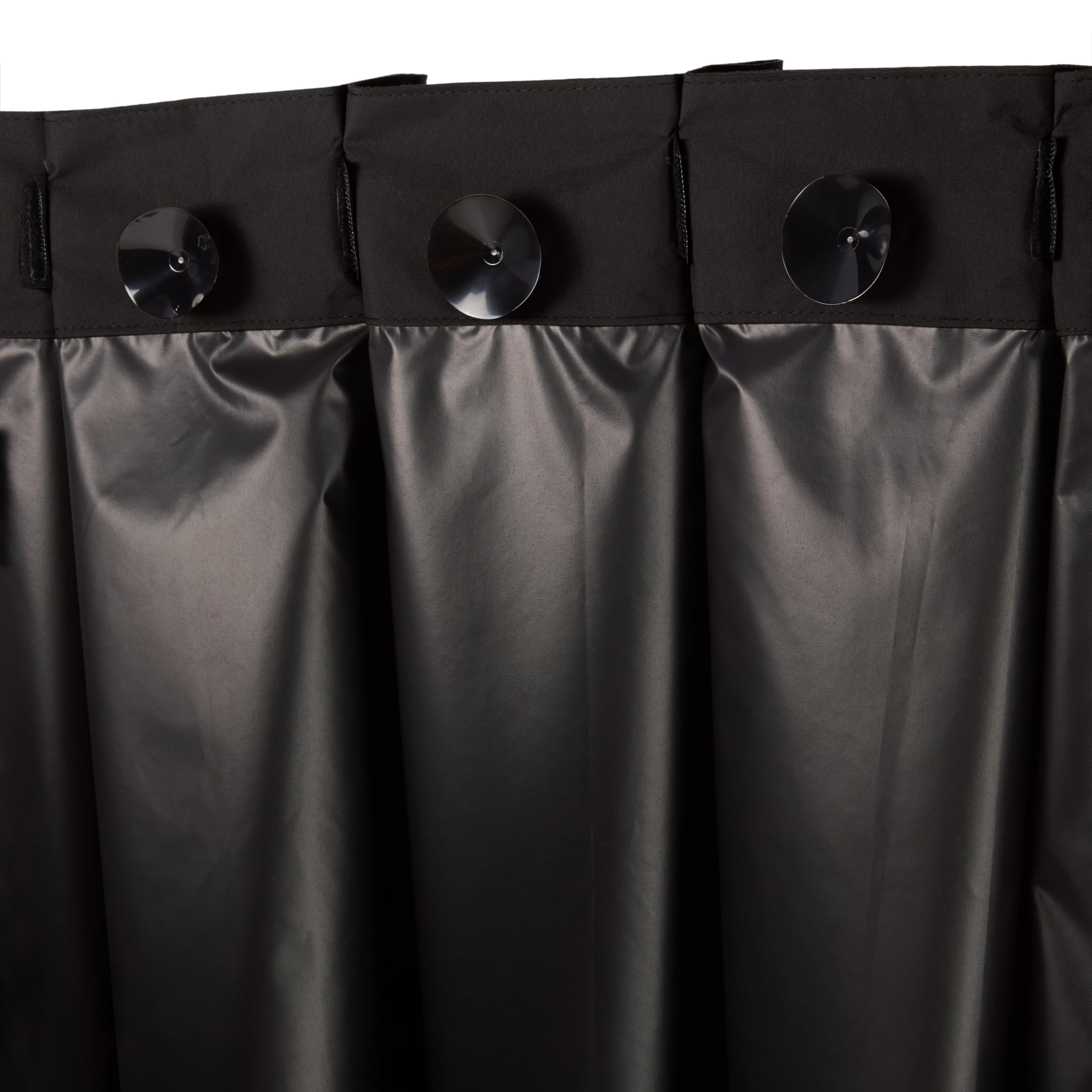 Amazon Basics curtain beside a hand for scale showing travel-friendly size and convenience