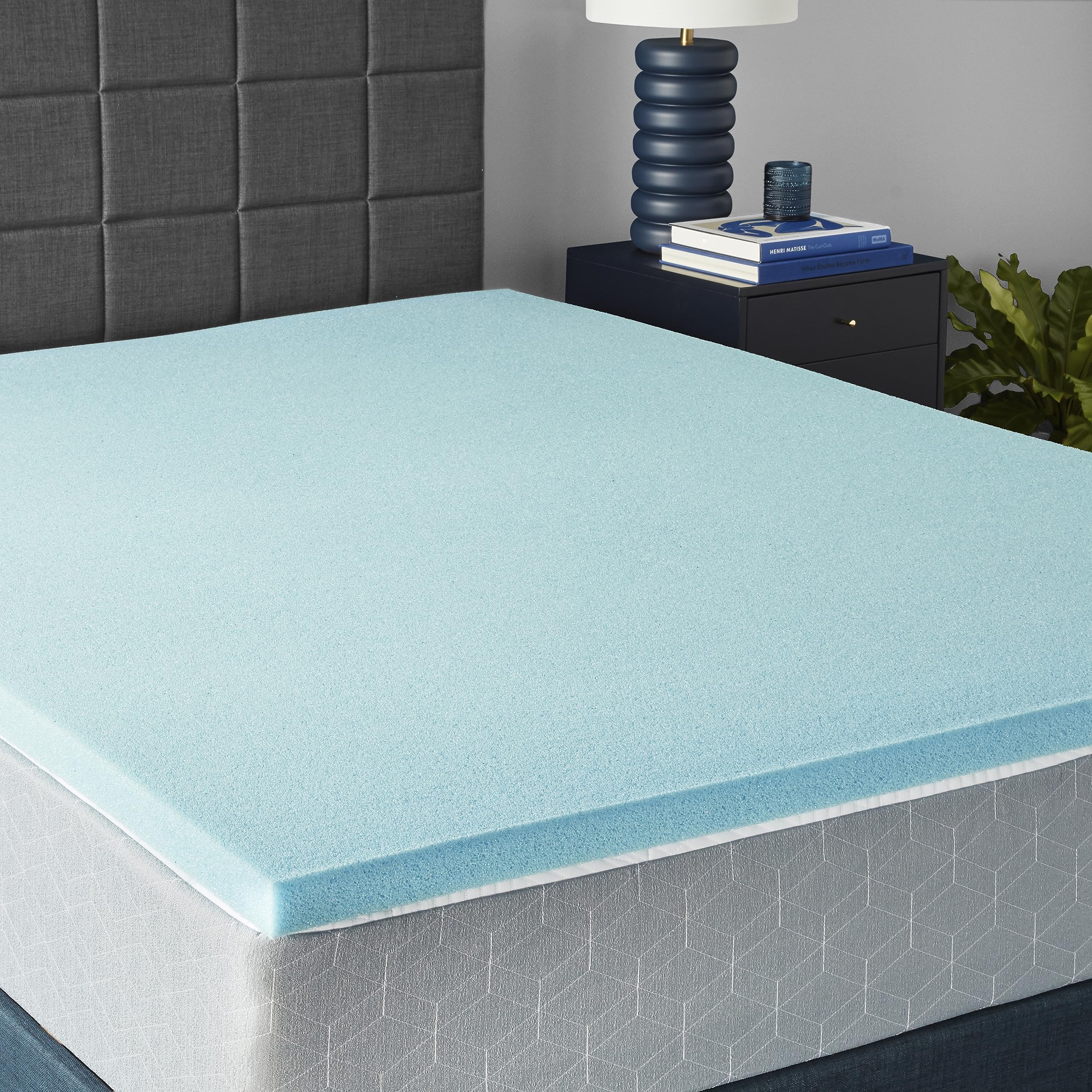 Amazon Basics topper on queen bed showing smooth surface and cooler sleep benefit