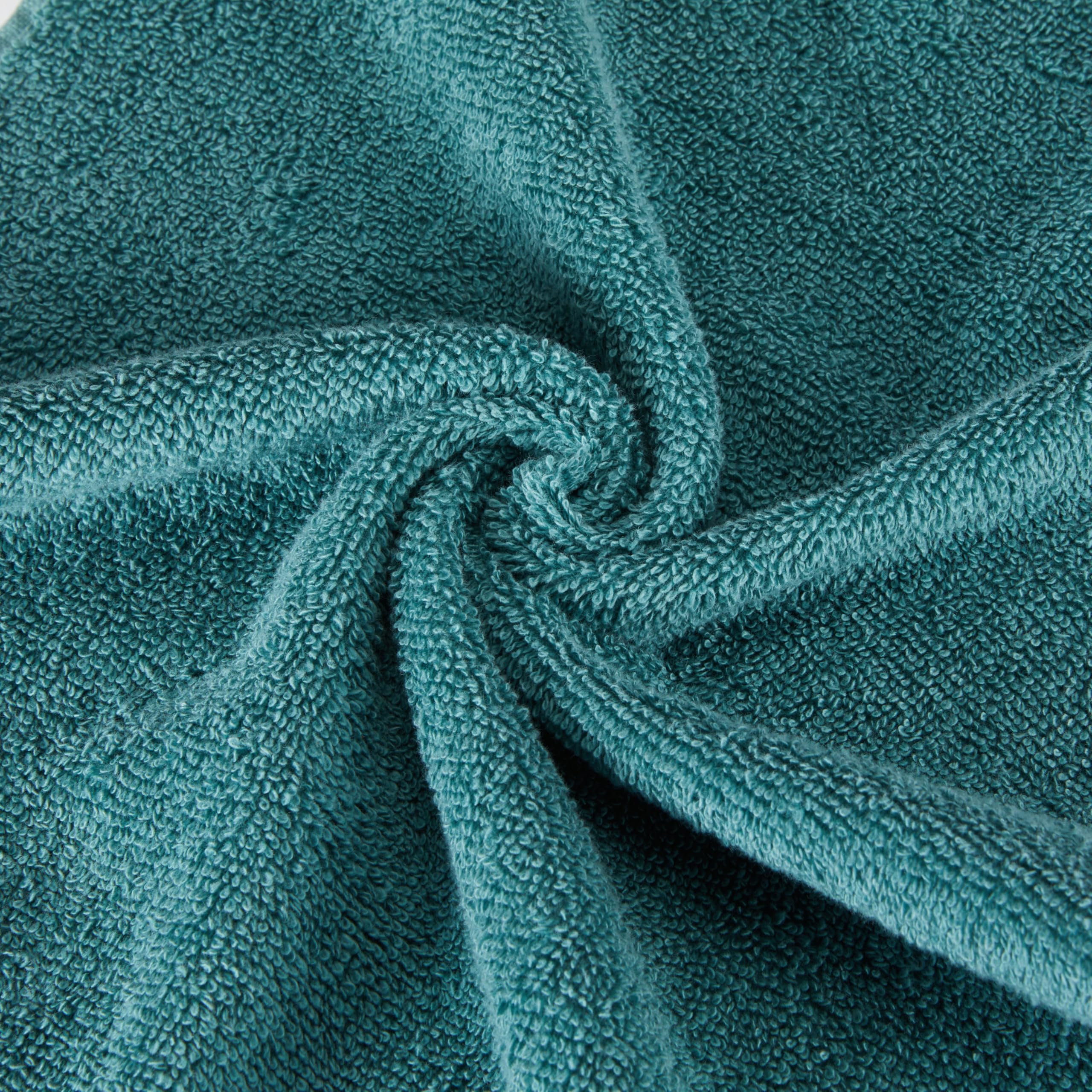 Amazon Basics towels displayed with objects showing size and versatility