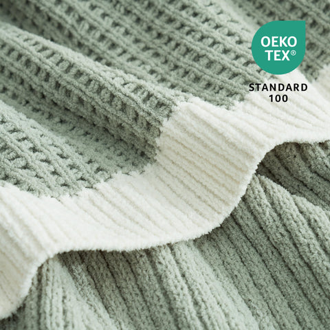 Amélie Home neatly folded throw on bed illustrating neat layering and refined bedroom accent