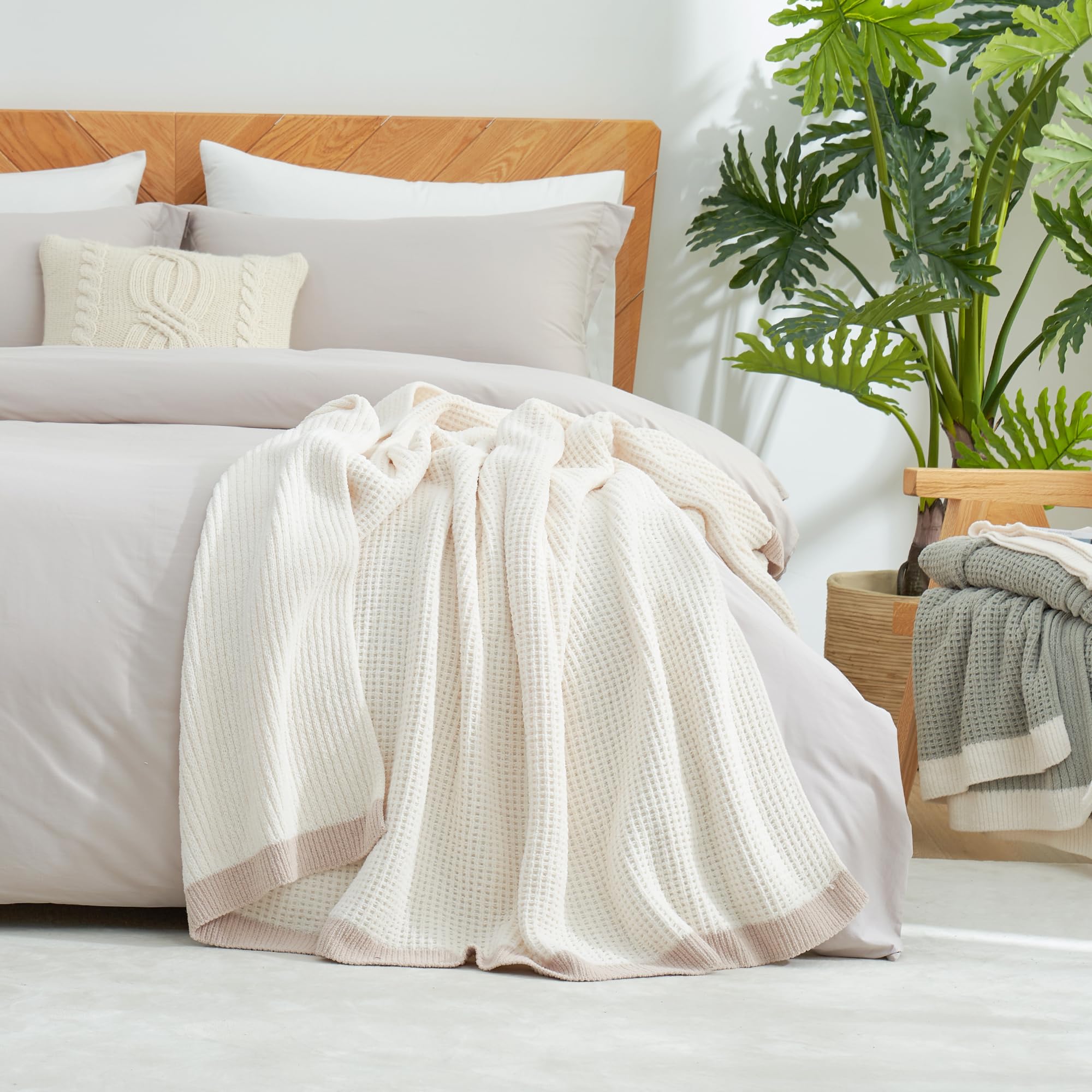 Amélie Home throw styled on bed showing layered decor and soft, inviting bedroom atmosphere