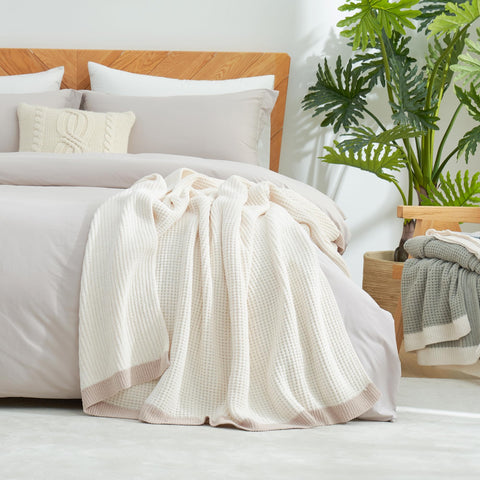 Amélie Home throw styled on bed showing layered decor and soft, inviting bedroom atmosphere