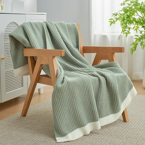 Amélie Home throw beside book to show scale and portability, convenient for reading or travel