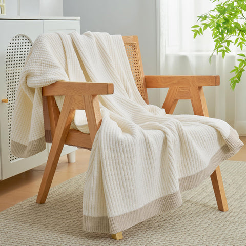 Amélie Home throw beside chair to illustrate 50x60 size and practical scale for couches