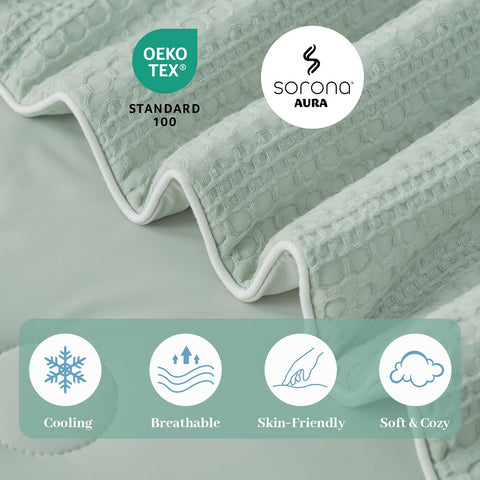 Amélie Home styled bed with sage comforter creating a calm bedroom atmosphere
