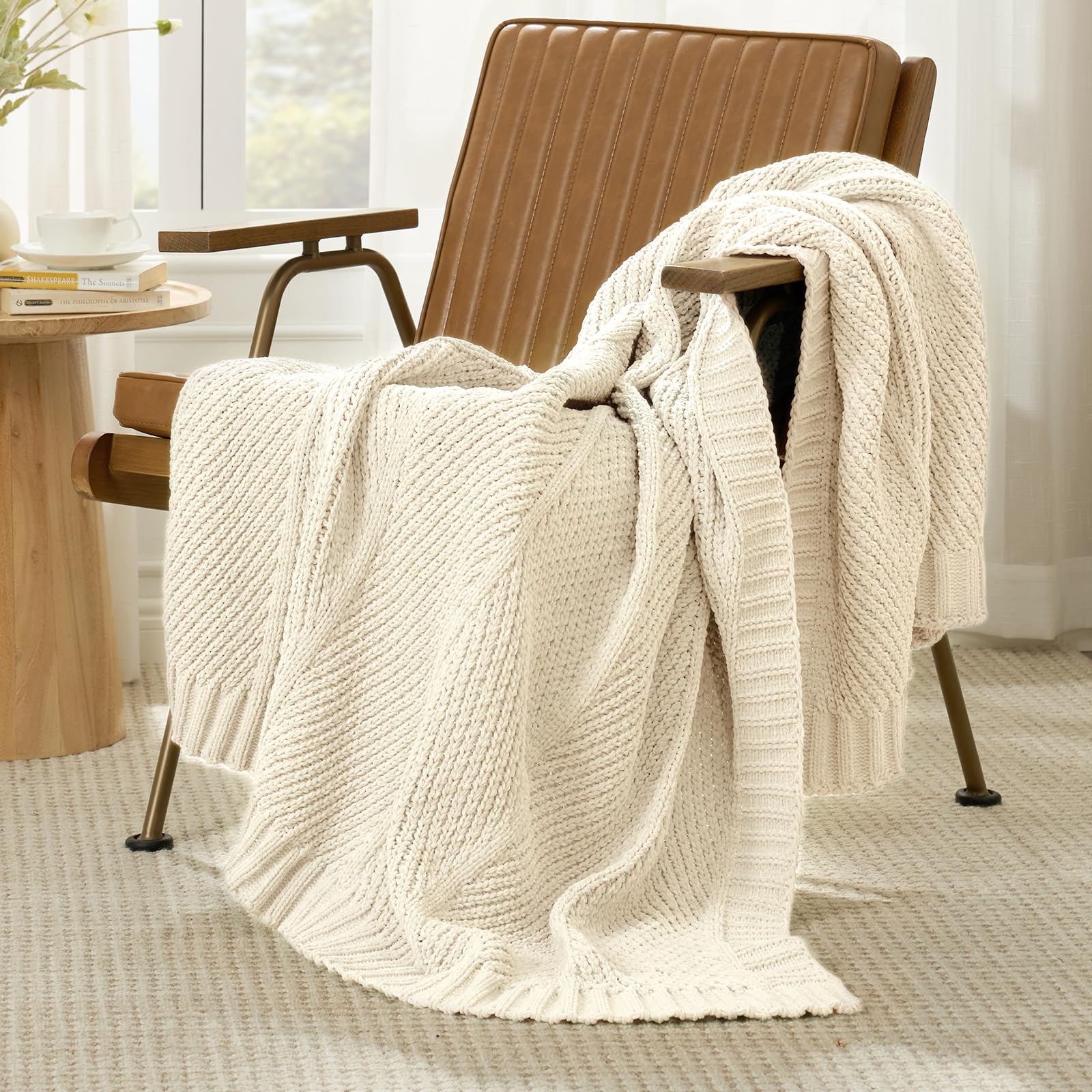 Amélie Home blanket draped over sofa adding warmth and layered living room style