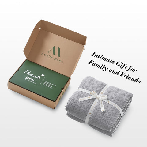 Amélie Home folded comforter comparing scale to a pillow for easy storage and portability benefit
