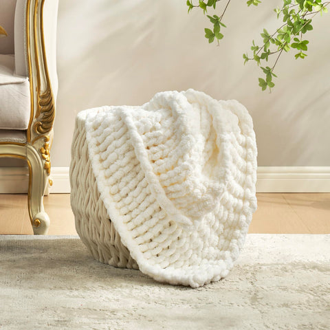 Amélie Home throw held to show plushness and gentle skin feel