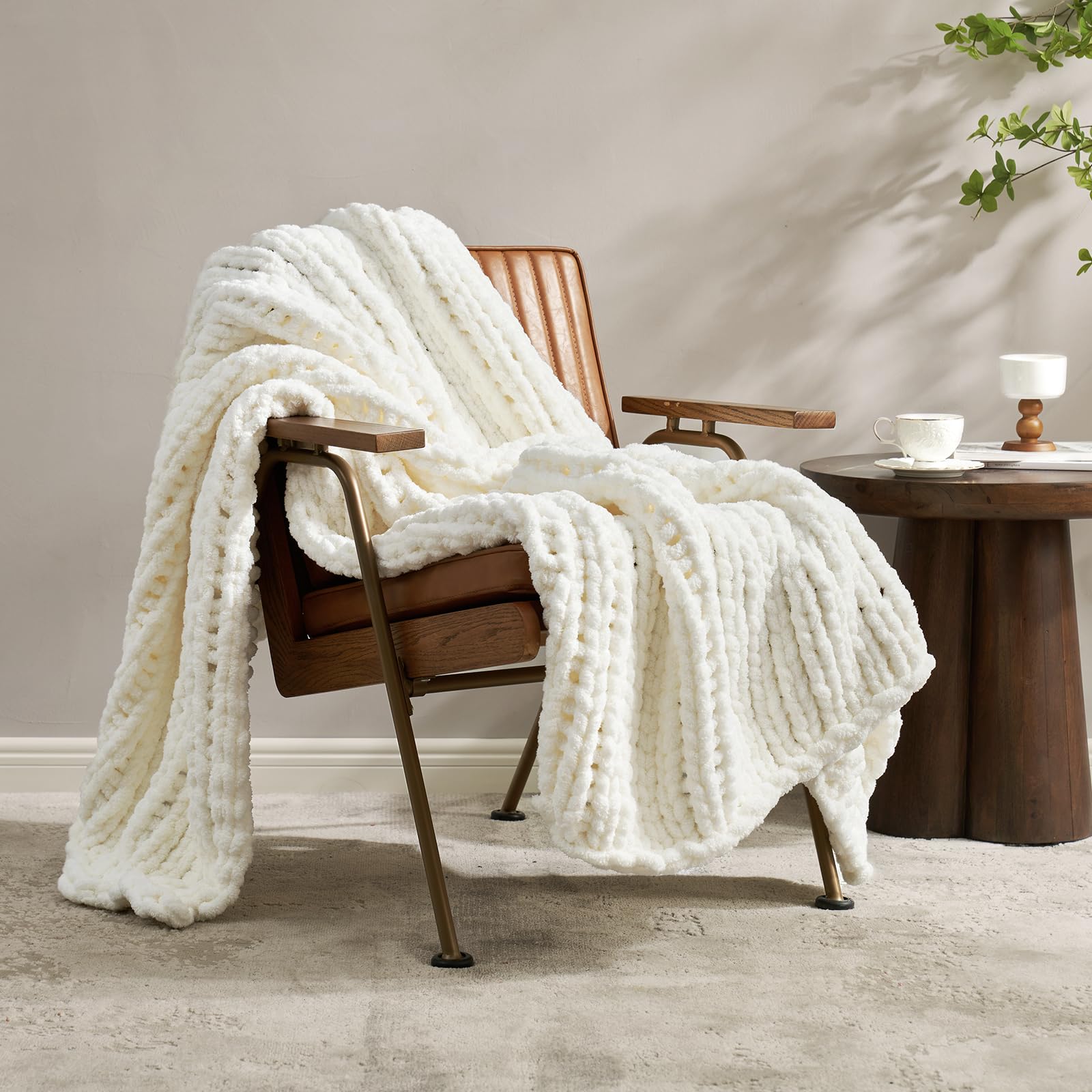 Amélie Home throw draped over sofa adding cozy neutral decor