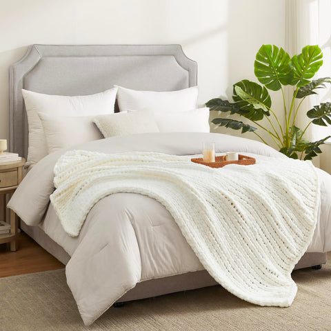 Amélie Home throw beside book showing 50x60 scale for sharing
