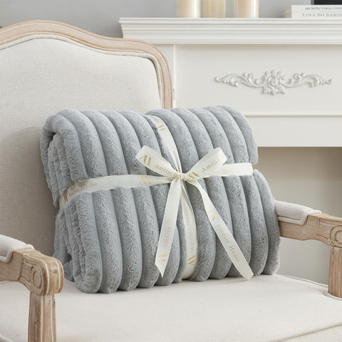Amélie Home size comparison on chair illustrating 55x70 generous scale
