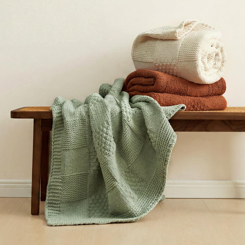 Amélie Home throw draped over sofa adding cozy, styled living room appeal
