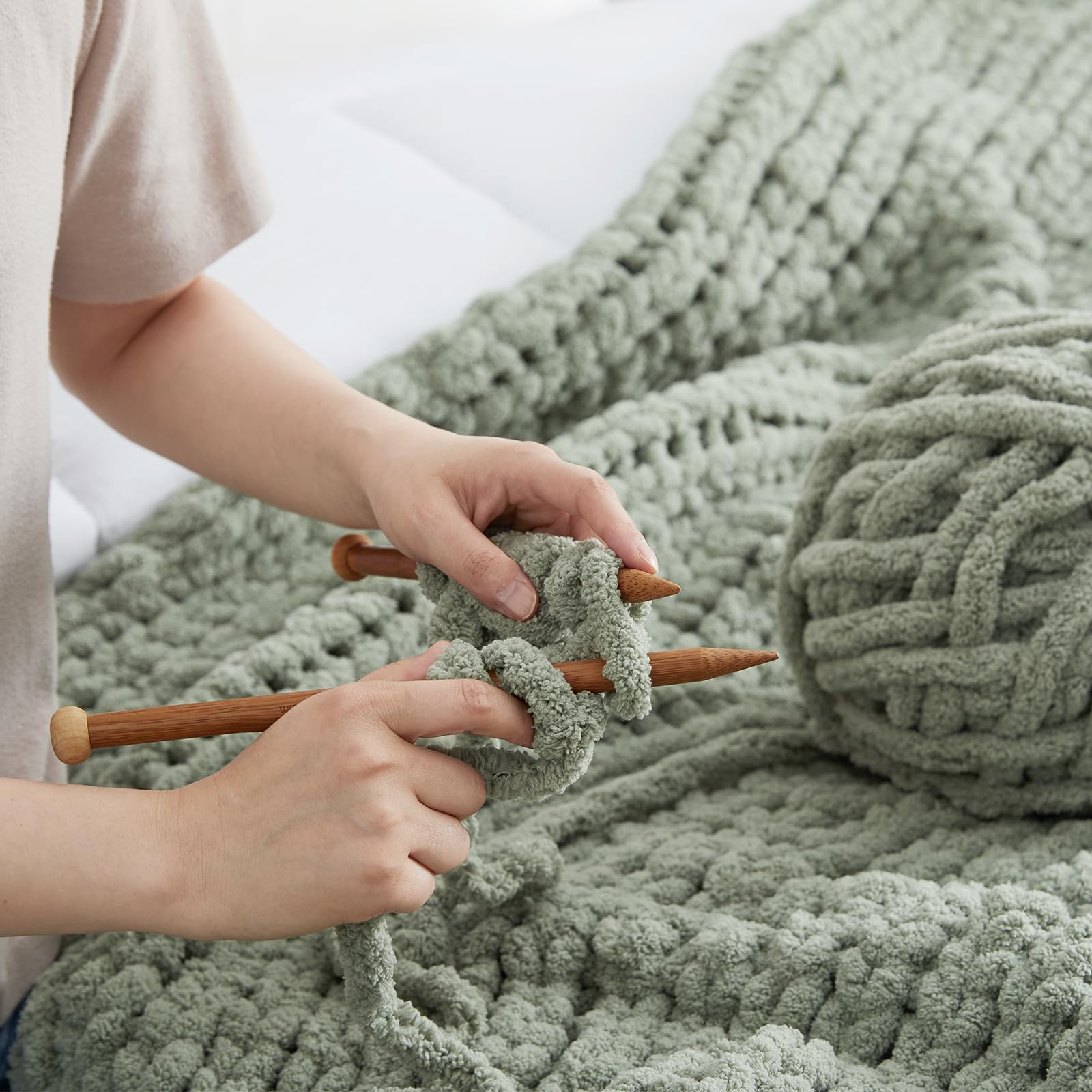 Amélie Home throw across lap to show 50x60 scale and portable convenience