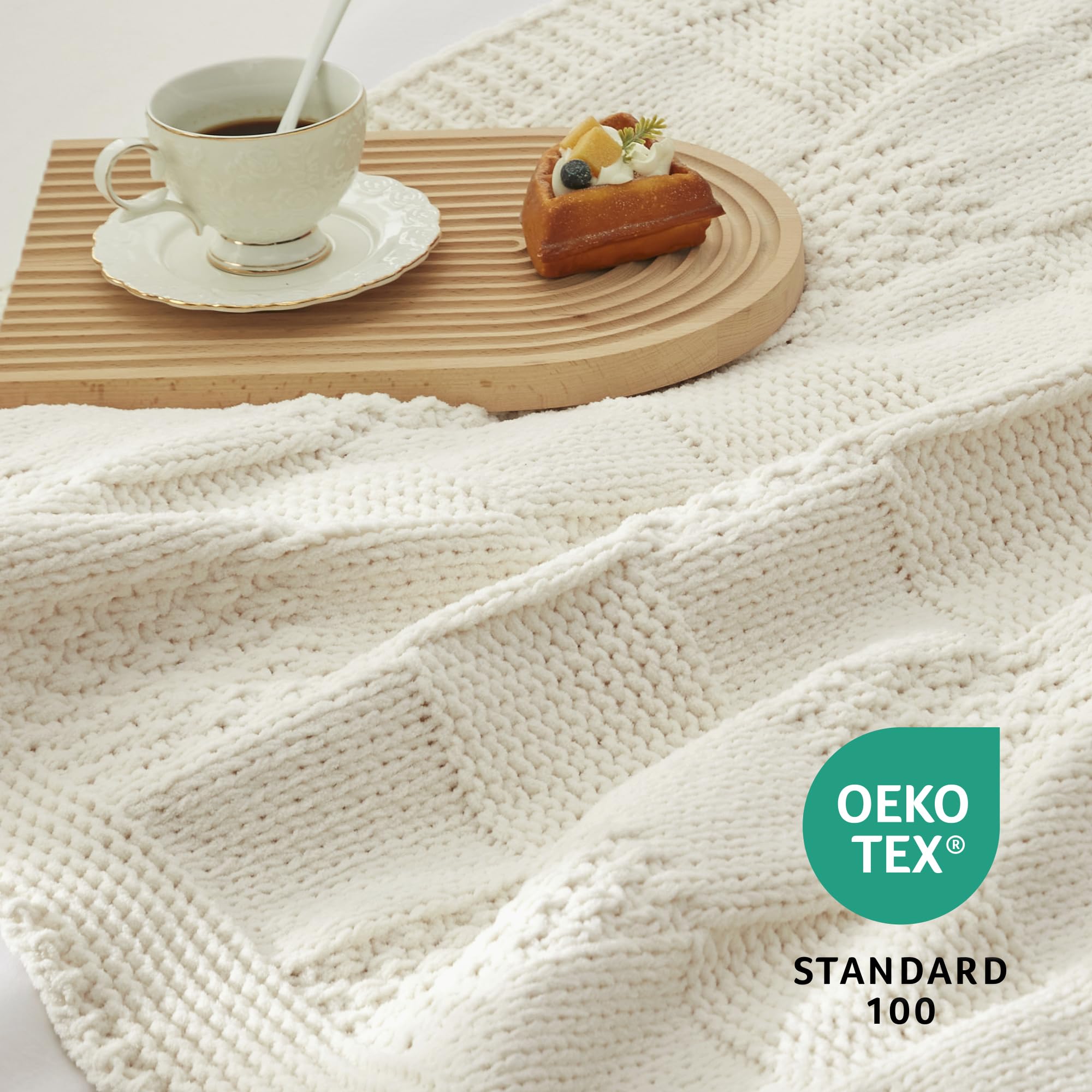 Amélie Home throw beside pillow showing 50x60 scale for accurate sizing