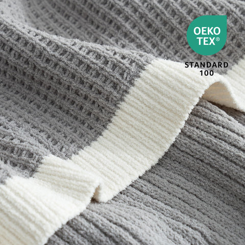 Amélie Home throw on couch shows 50x60 scale and usable size