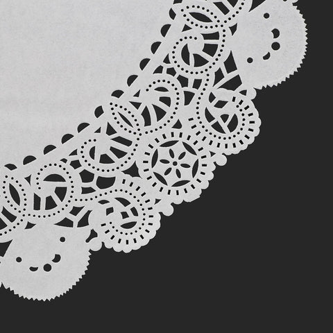AmerCareRoyal doily placed under cupcake illustrating how it enhances dessert presentation