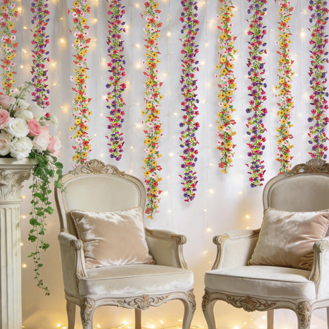 Ammyoo garlands hung on wedding arch creating full, photograph-ready backdrop