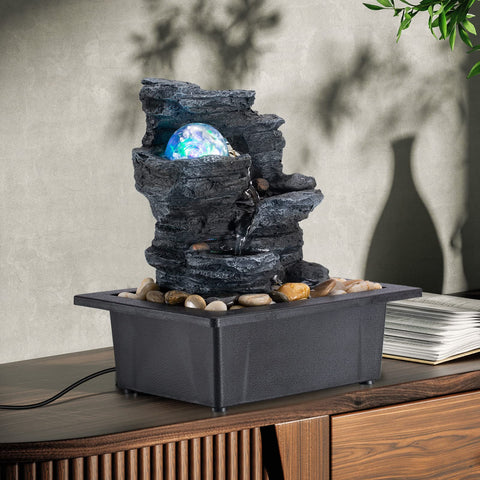 AMOOTEK fountain next to a hand showing compact size and easy tabletop placement