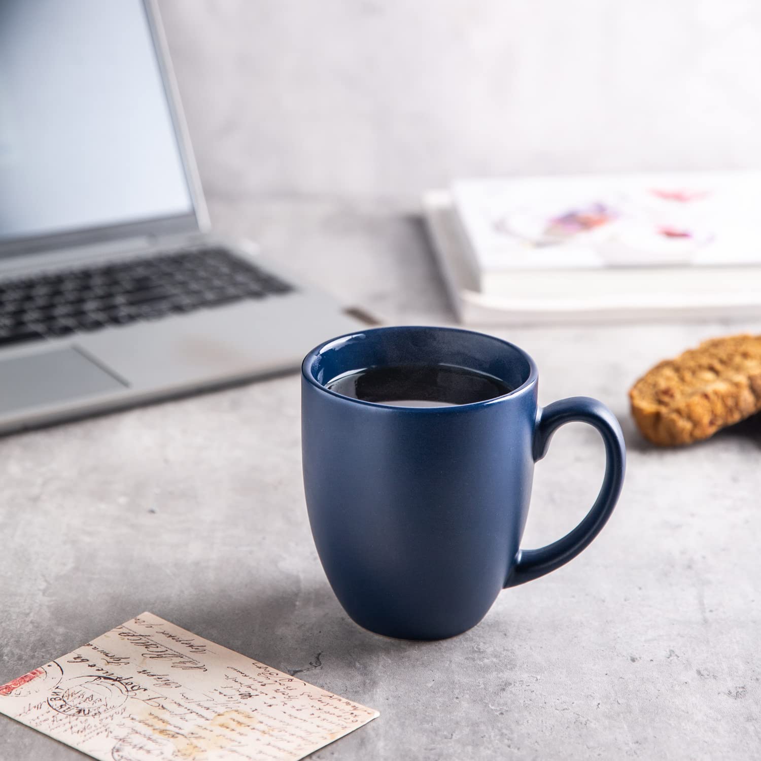 AmorArc mug beside hand to show real-world scale and comfortable hold