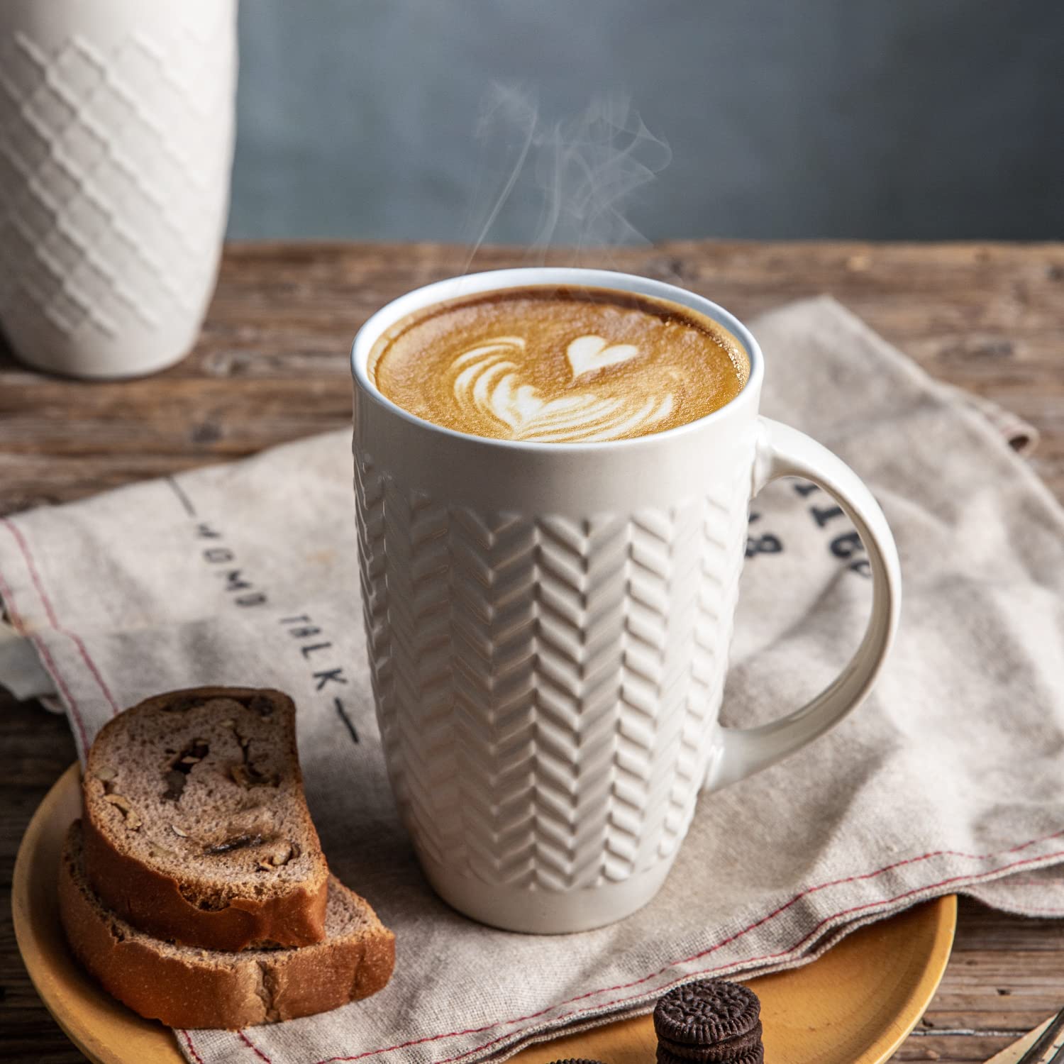 AmorArc mug held in hand showing 20 oz scale and generous capacity benefit
