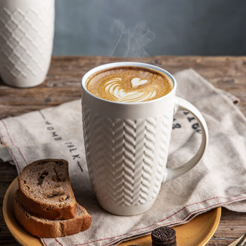 AmorArc mug held in hand showing 20 oz scale and generous capacity benefit