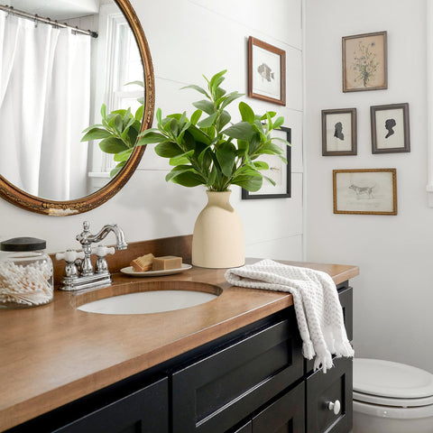 Amore Florals on bathroom counter, offers humidity-resistant greenery solution