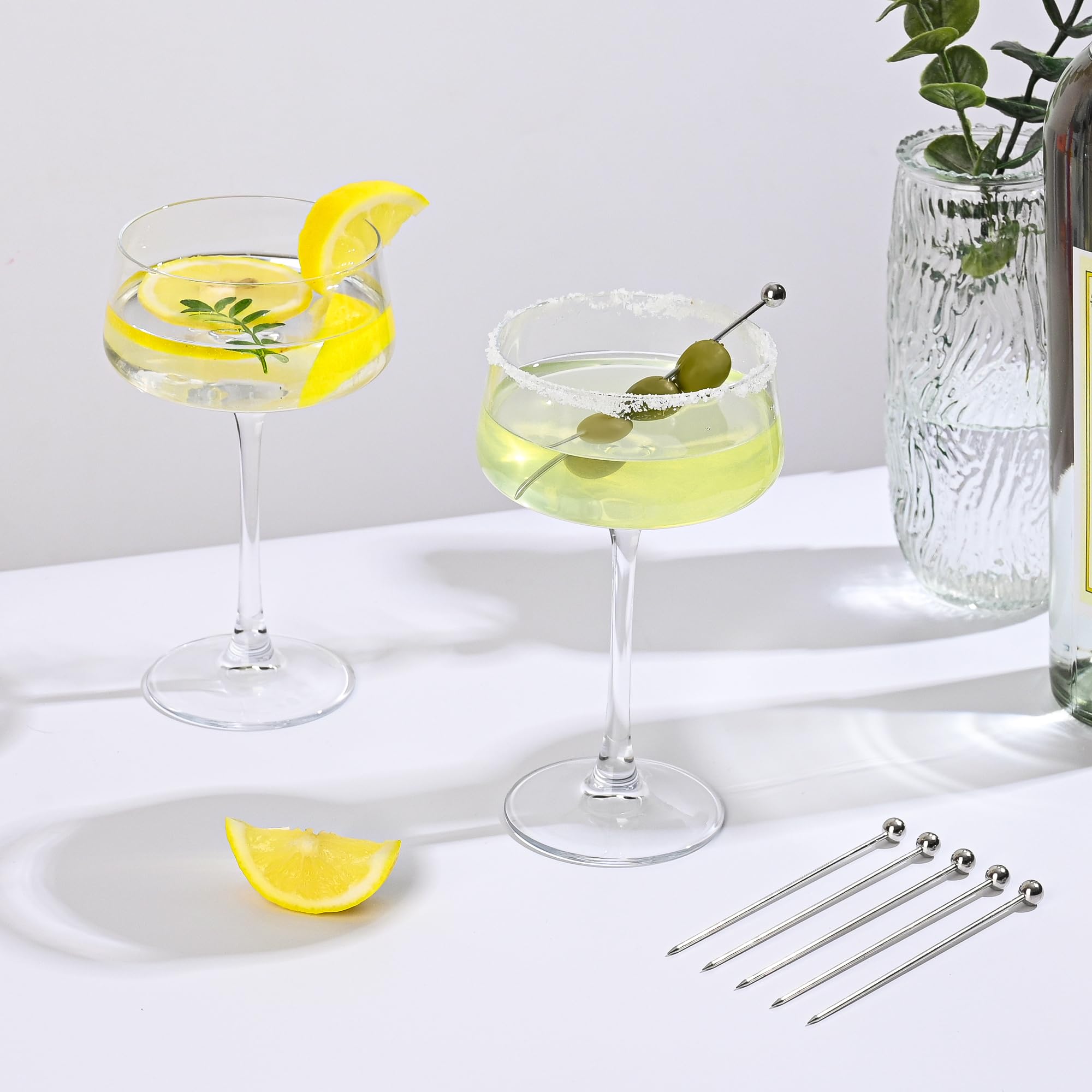 Amyoole coupe glass filled with cocktail, showcases garnish and foam attractively
