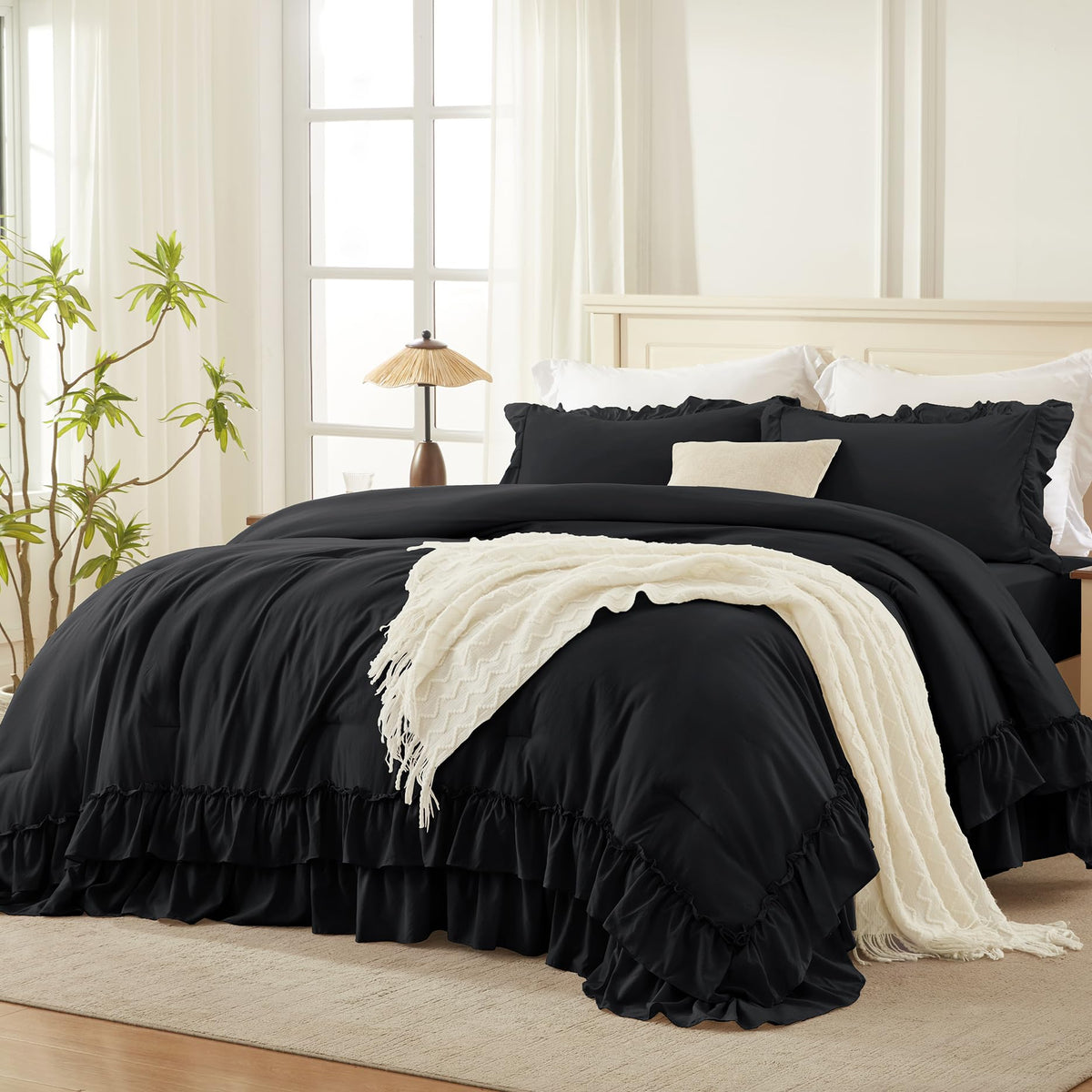 Andency front view on bed showing elegant ruffle and full coverage