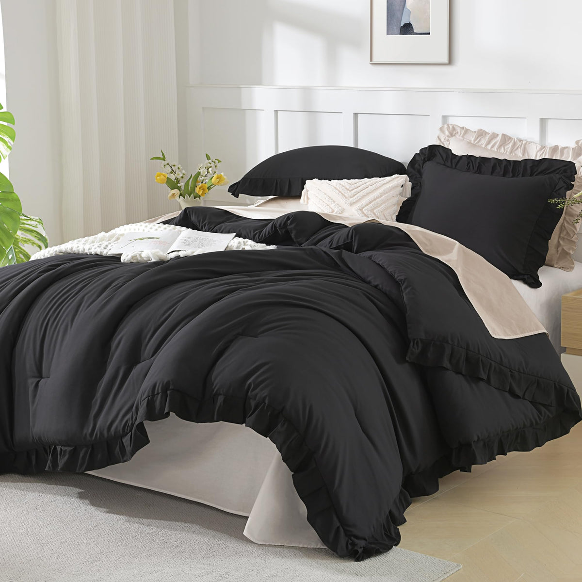 Andency front view comforter on bed showing ruffled edges and elegant black finish for stylish bedding