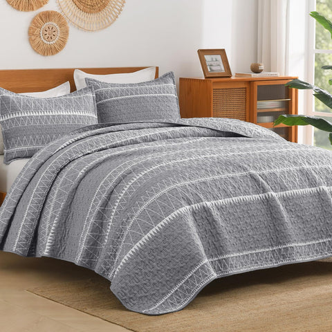 Andency front view bedspread showing grey boho stripes and neat drape benefit: modern calm