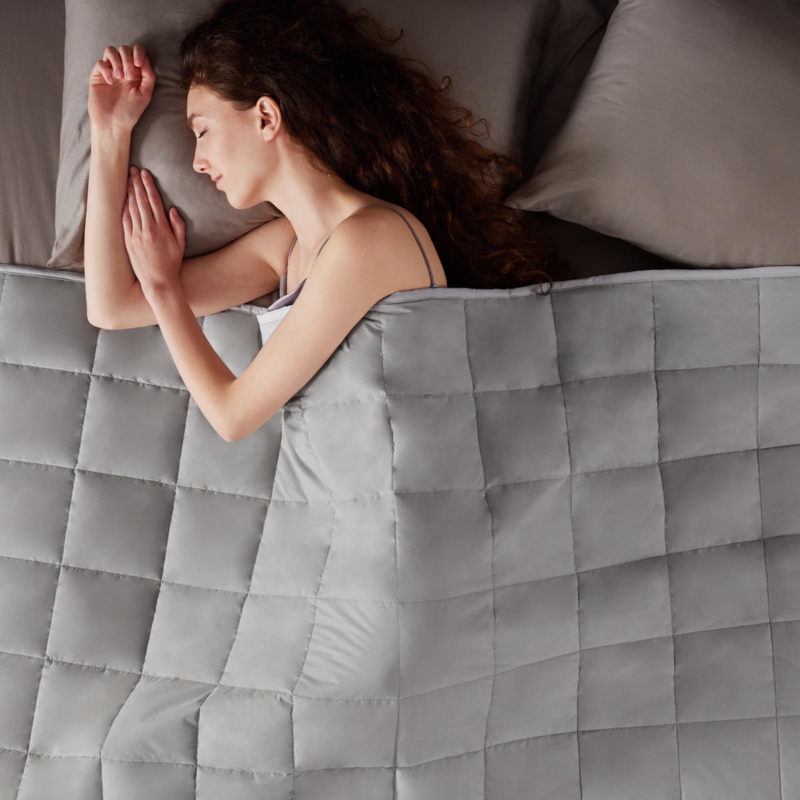 anfie styled on bedroom bed showing neutral stone grey complements décor