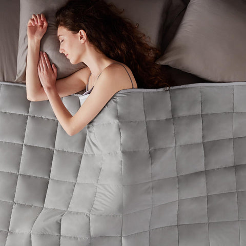 anfie styled on bedroom bed showing neutral stone grey complements décor