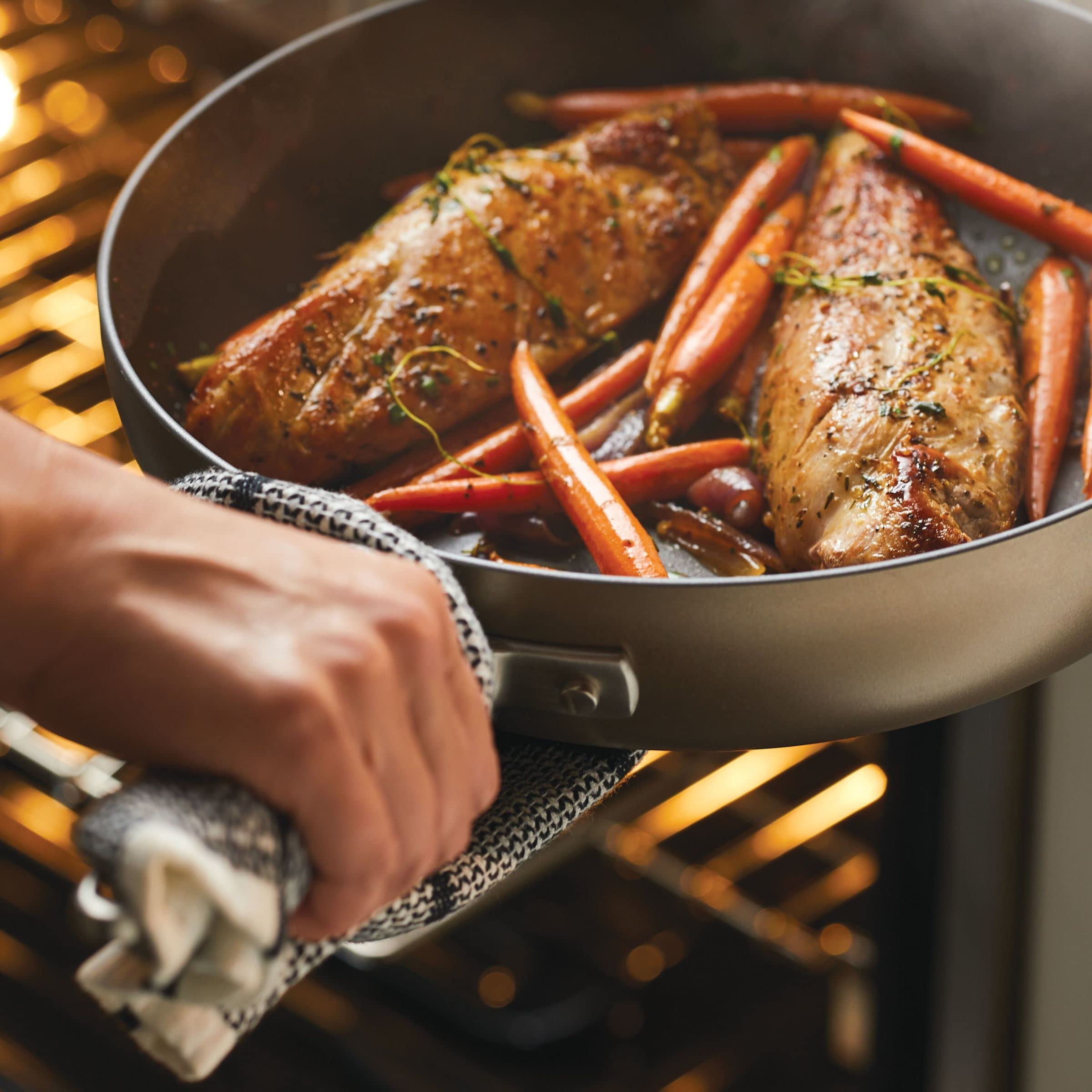 Anolon pan next to plate for size scale to visualize 12-inch capacity