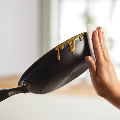 Anolon skillet on kitchen counter in use suggesting everyday cooking convenience benefit