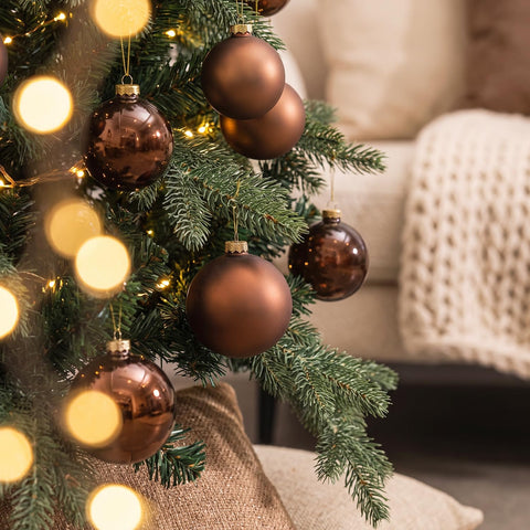 AOMOONOA baubles hung on a tree adding warm, coordinated accents