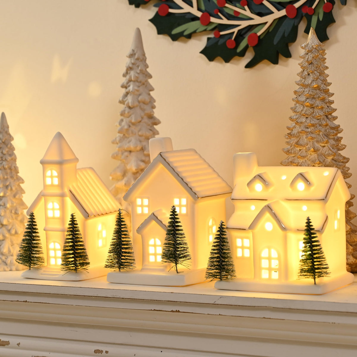 AOMOONOA front view of three white ceramic houses adding warm holiday charm
