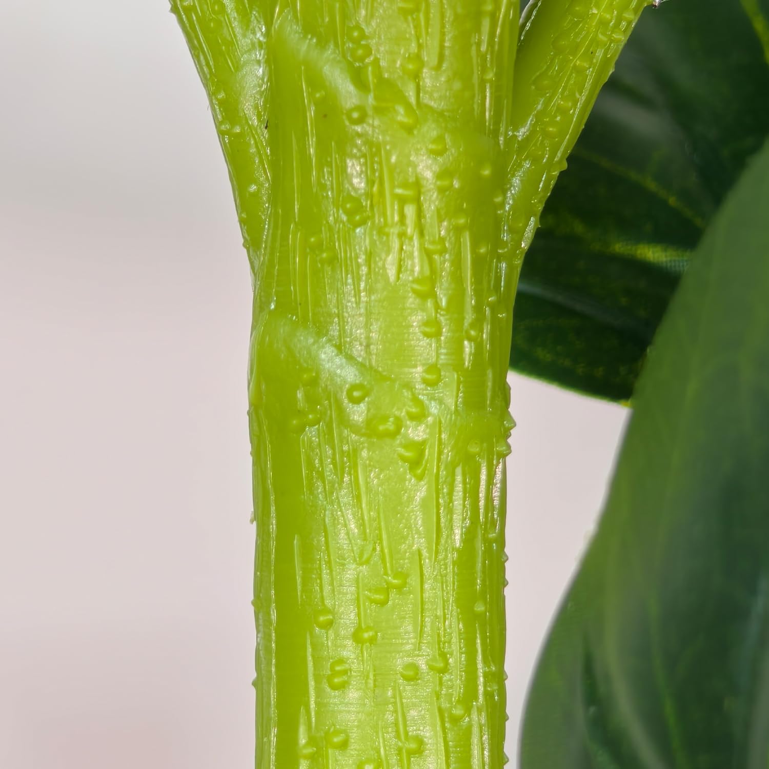 Aoxiwhcse leaf being wiped clean demonstrating easy-care, dust-resistant material