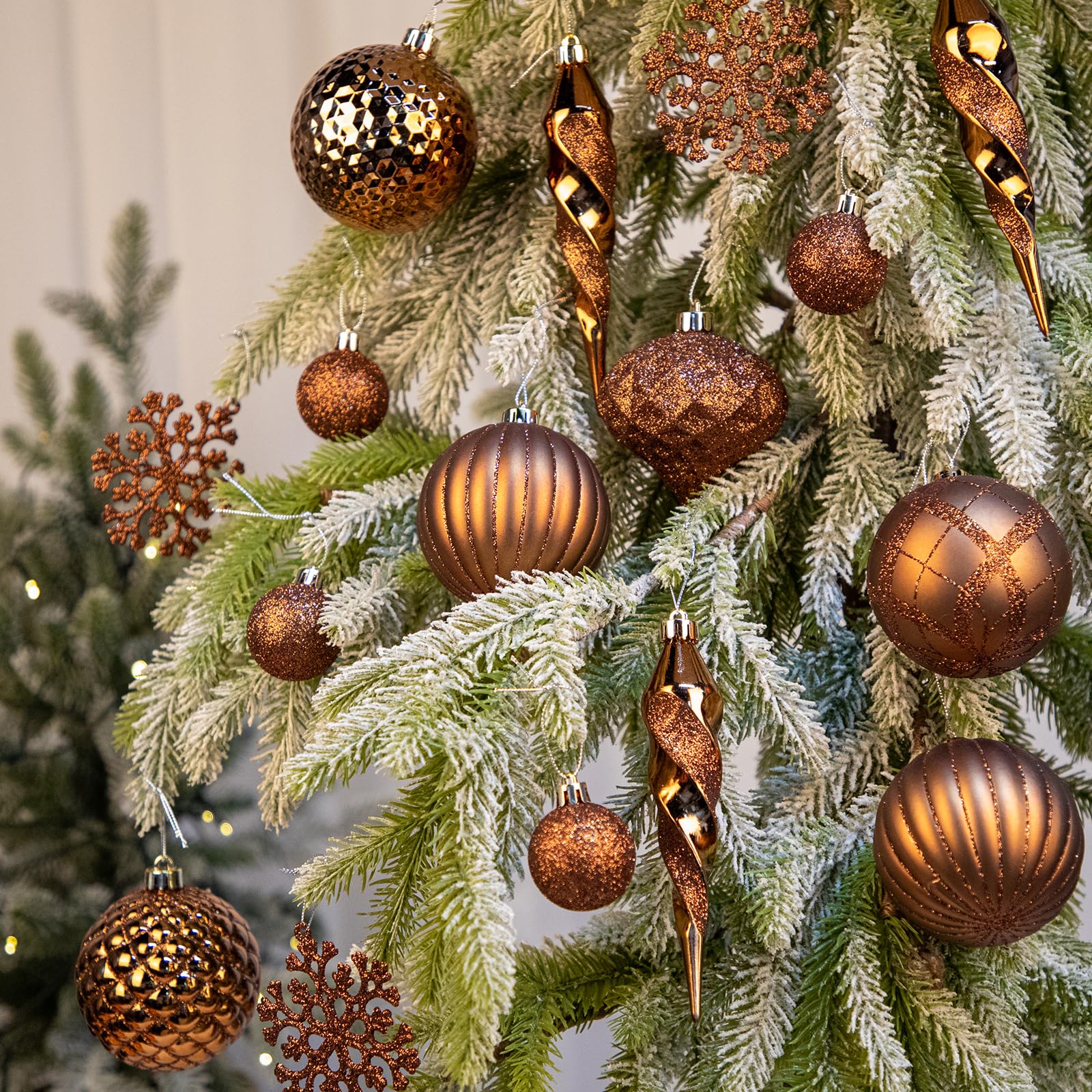 Arborus bronze ornaments hanging on a decorated tree showing cohesive warm glow