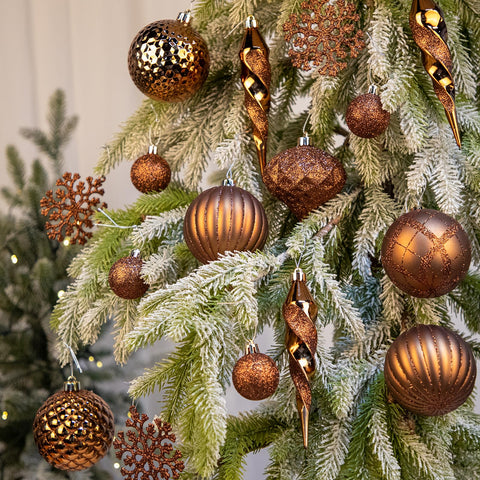 Arborus bronze ornaments hanging on a decorated tree showing cohesive warm glow