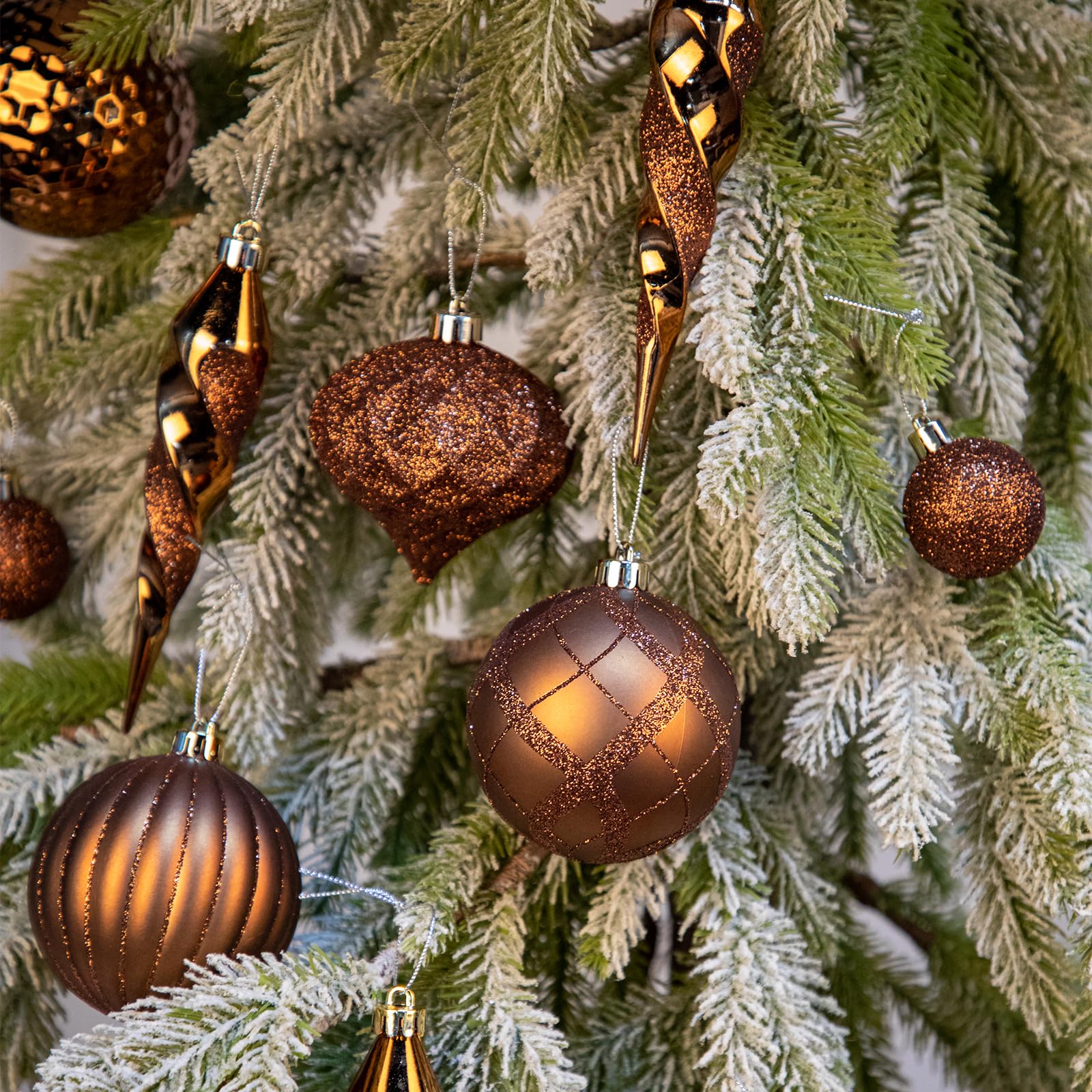 Arborus bronze ornaments beside a ruler showing size range for decorating ease